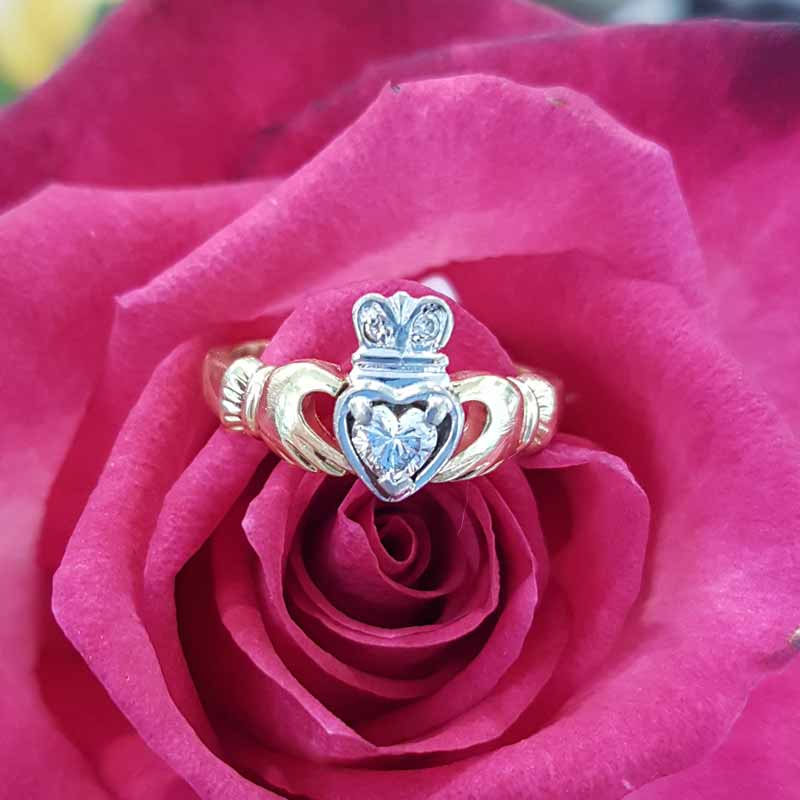 Gold ring - hand holding heart-shaped diamond
