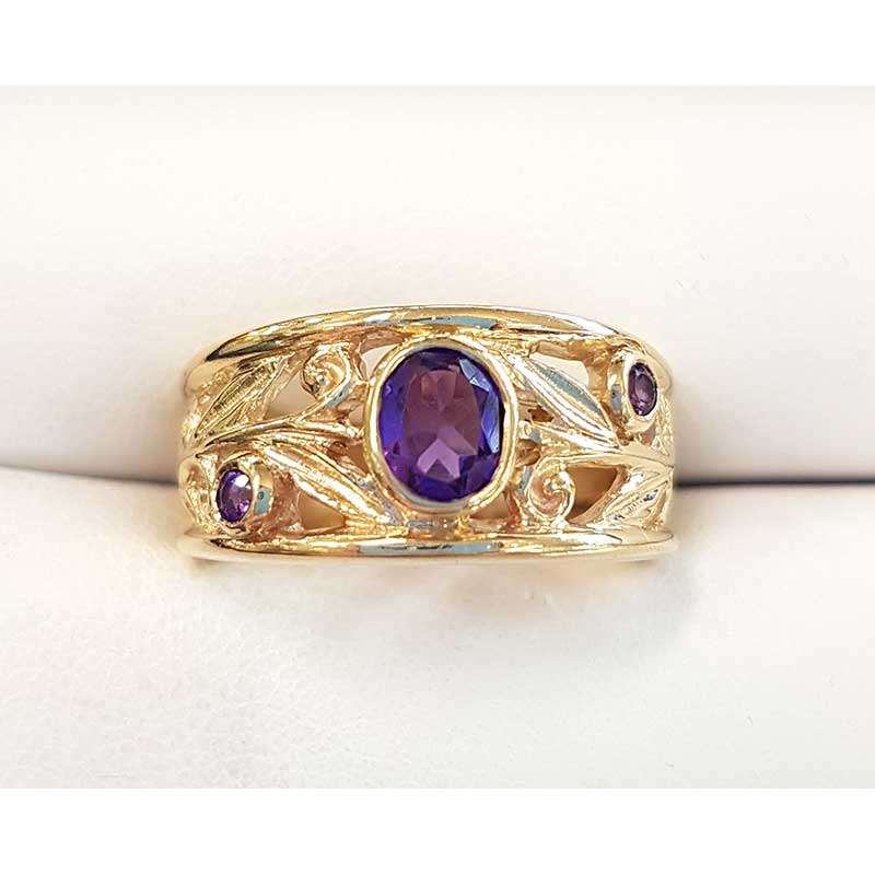 Gold ring featuring 3 oval amethysts