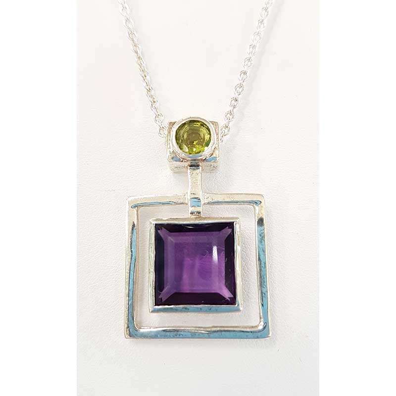 Square amethyst set in sterling silver framed setting with green period and silver chain necklace