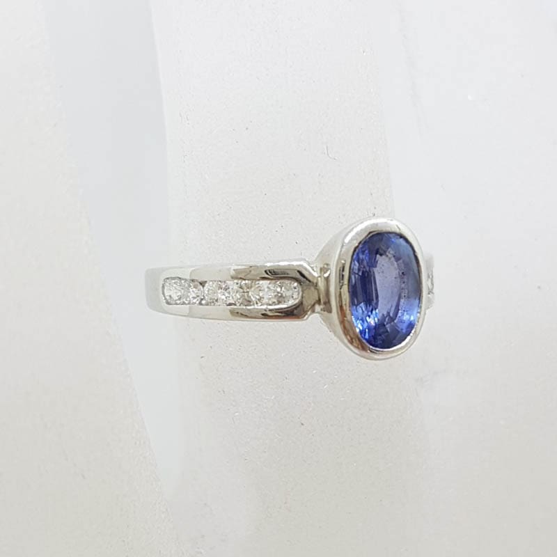 18ct White Gold Oval Bezel Set Natural Blue Ceylon Sapphire with Channel Set Diamond Ring