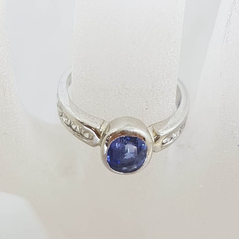 18ct White Gold Oval Bezel Set Natural Blue Ceylon Sapphire with Channel Set Diamond Ring