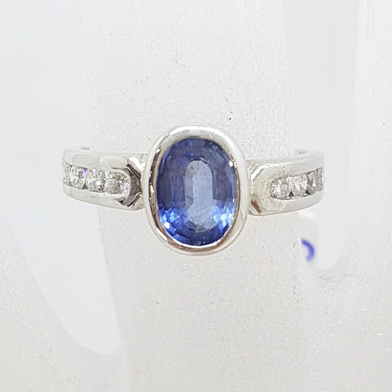 18ct White Gold Oval Bezel Set Natural Blue Ceylon Sapphire with Channel Set Diamond Ring