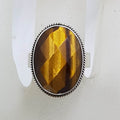 Sterling Silver Large Oval Faceted Tiger Eye Ring - Patterned Rim