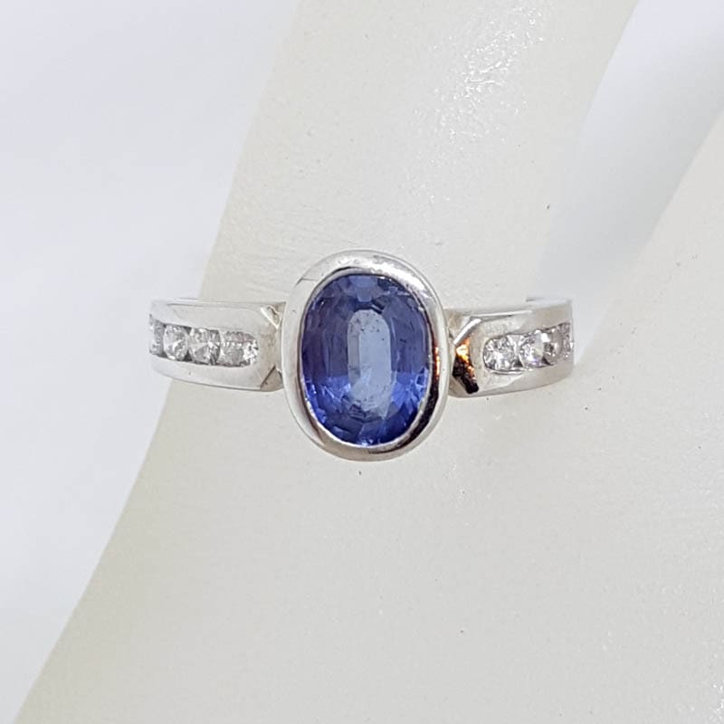 18ct White Gold Oval Bezel Set Natural Blue Ceylon Sapphire with Channel Set Diamond Ring