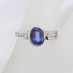 18ct White Gold Oval Bezel Set Natural Blue Ceylon Sapphire with Channel Set Diamond Ring