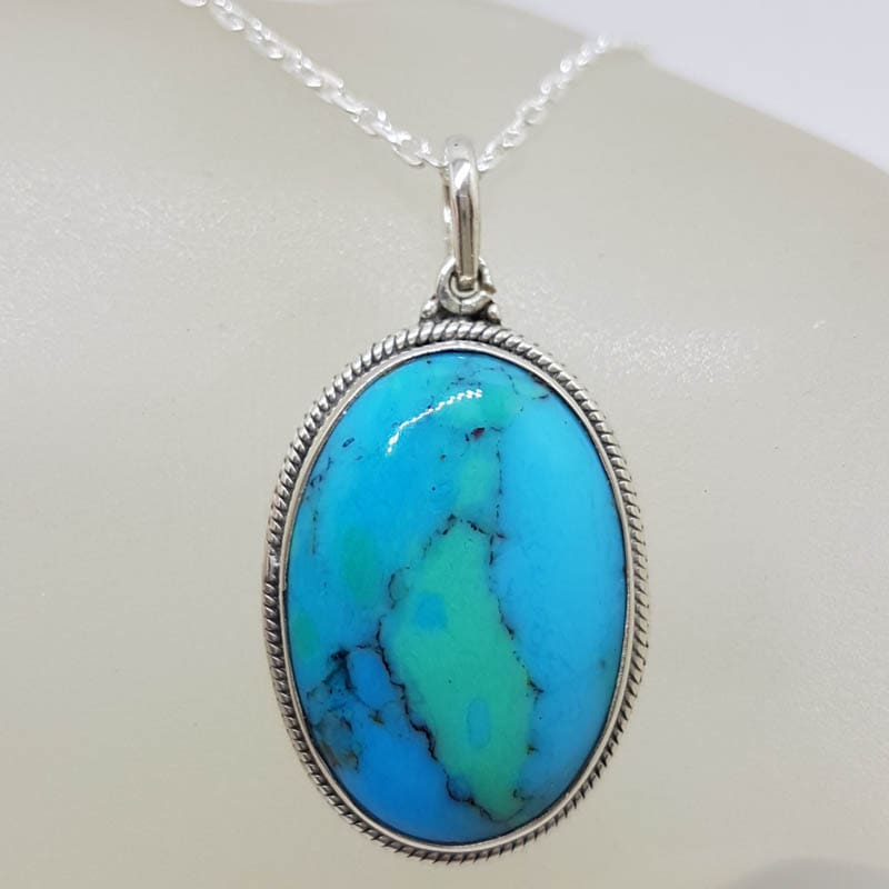 Sterling Silver Turquoise Oval with Patterned Rim around Bezel Set Pendant on Silver Chain