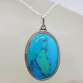 Sterling Silver Turquoise Oval with Patterned Rim around Bezel Set Pendant on Silver Chain
