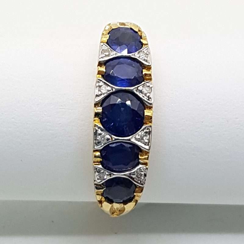 9ct gold ring 5 blue sapphires with diamonds in a Bridge setting