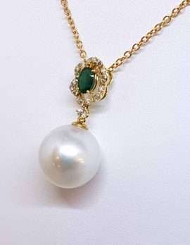 Pearl drop necklace with on gold chain and oval emerald