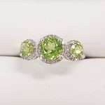 9ct gold ring featuring 3 round peridot gems and diamond ring