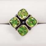 sterling silver ring featuring four peridot gems