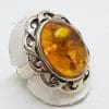 Sterling Silver Large Oval Natural Amber Ring with Twist Design