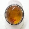 Sterling Silver Large Round Natural Amber Ring - With Twist Design Rim