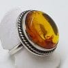 Sterling Silver Large Round Natural Amber Ring - With Twist Design Rim