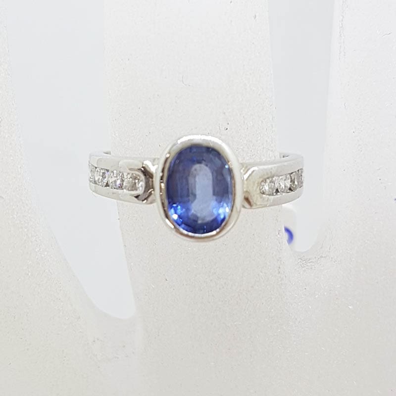 20210601_221338 18ct White Gold Oval Bezel Set Blue Ceylon Sapphire with Channel Set Diamond Ring