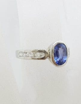 18ct White Gold Oval Bezel Set Blue Ceylon Sapphire with Channel Set Diamond Ring