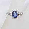 18ct White Gold Oval Bezel Set Natural Blue Ceylon Sapphire with Channel Set Diamond Ring
