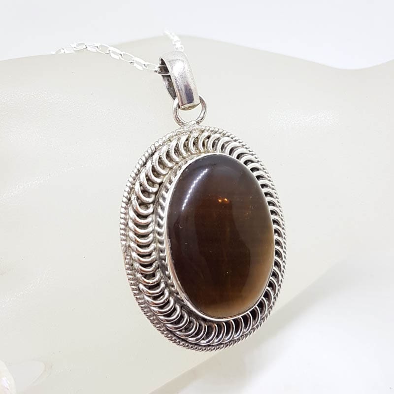 Sterling Silver Tiger Eye Large Oval Bezel Set Ornate Patterned Rim Pendant on Silver Chain Sterling Silver Tiger Eye Large Oval Bezel Set Ornate Patterned Rim Pendant on Silver Chain