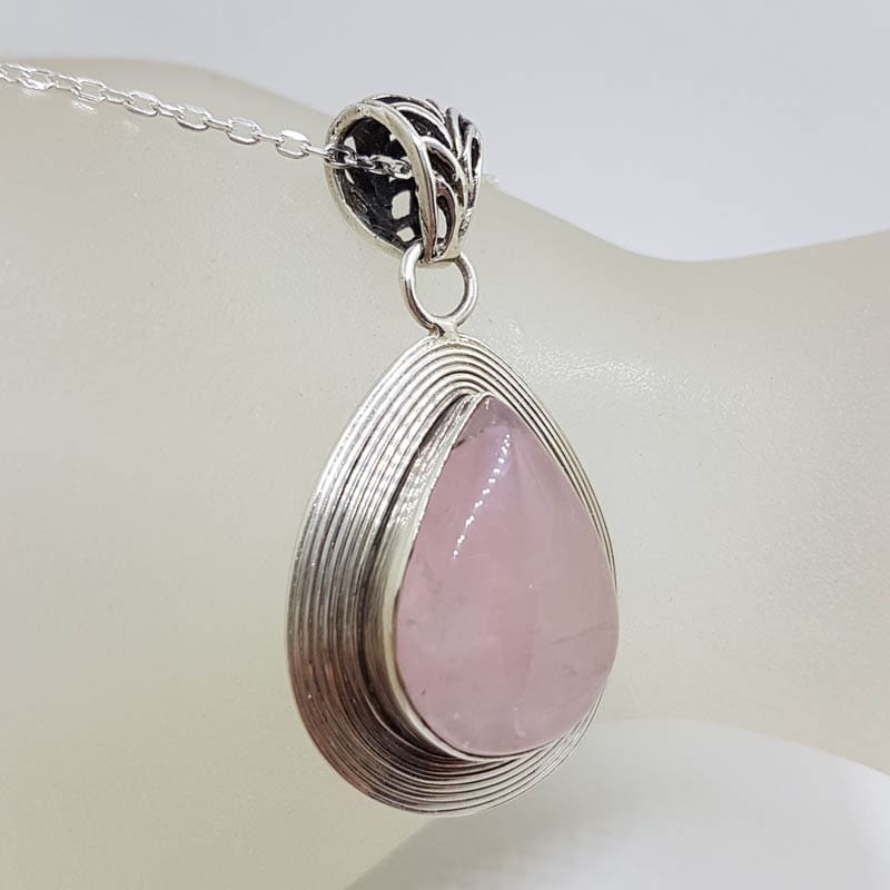 Sterling Silver Rose Quartz Teardrop / Pear Shape with Wide Patterned Rim Pendant on Silver Chain Sterling Silver Rose Quartz Teardrop / Pear Shape with Wide Patterned Rim Pendant on Silver Chain