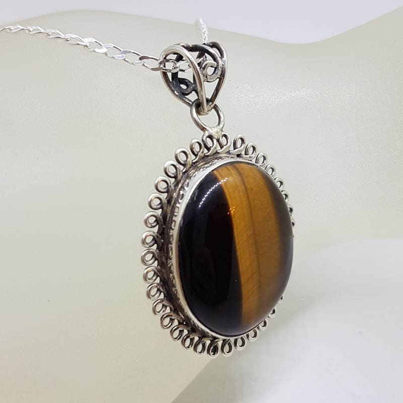 Sterling Silver Tiger Eye Cabochon Cut Oval Twist Rim Pendant on Silver Chain Sterling Silver Tiger Eye Cabochon Cut Oval Twist Rim Pendant on Silver Chain