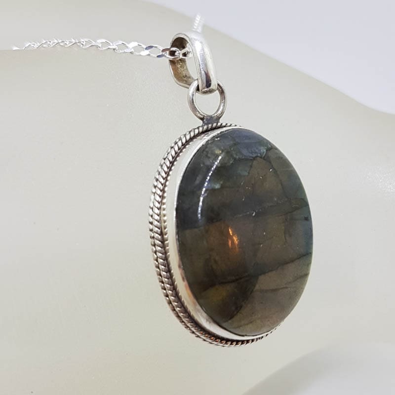 Sterling Silver Labradorite Cabochon Cut Oval with Patterned Rim Pendant on Silver Chain Sterling Silver Labradorite Cabochon Cut Oval with Patterned Rim Pendant on Silver Chain