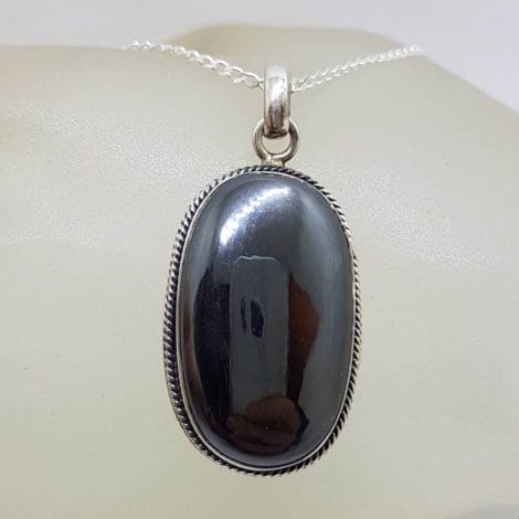 Sterling Silver Iron Ore / Hematite Bezel Set Oval with Twist Design on Rim Pendant on Silver Chain