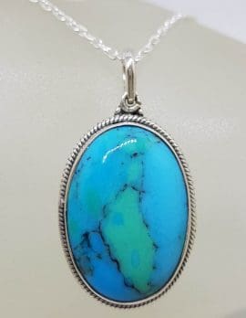 Sterling Silver Turquoise Oval with Patterned Rim around Bezel Set Pendant on Silver Chain