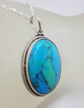 Sterling Silver Turquoise Oval with Patterned Rim around Bezel Set Pendant on Silver Chain