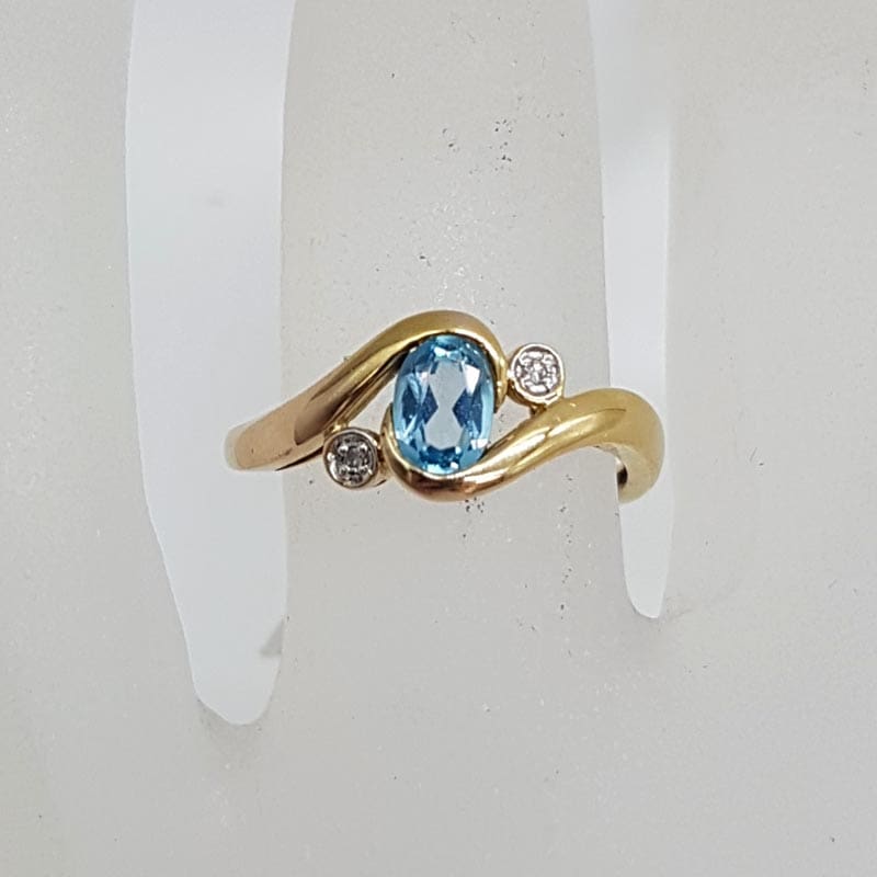 9ct Yellow Gold Oval Topaz with Two Diamonds Curved Ring