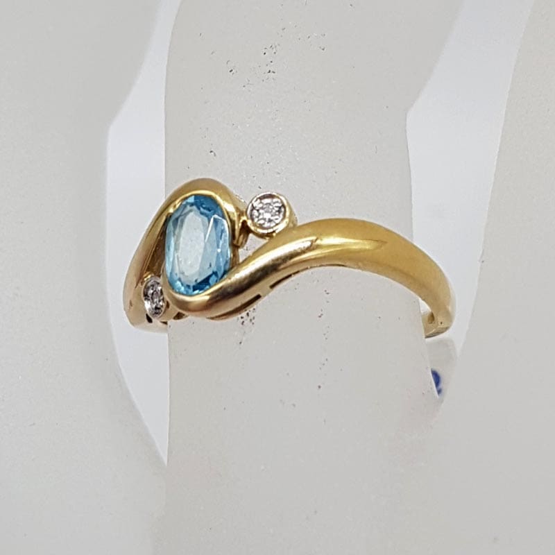 9ct Yellow Gold Oval Topaz with Two Diamonds Curved Ring