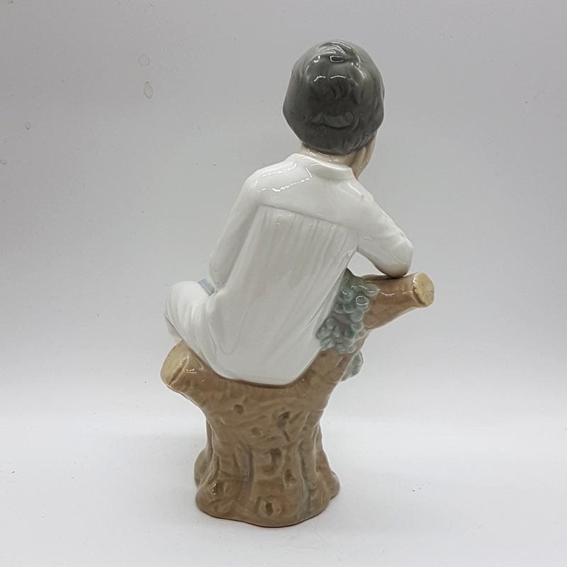 Lladro Thinking Boy Sitting on a Branch Figurine Lladro Thinking Boy Sitting on a Branch Figurine