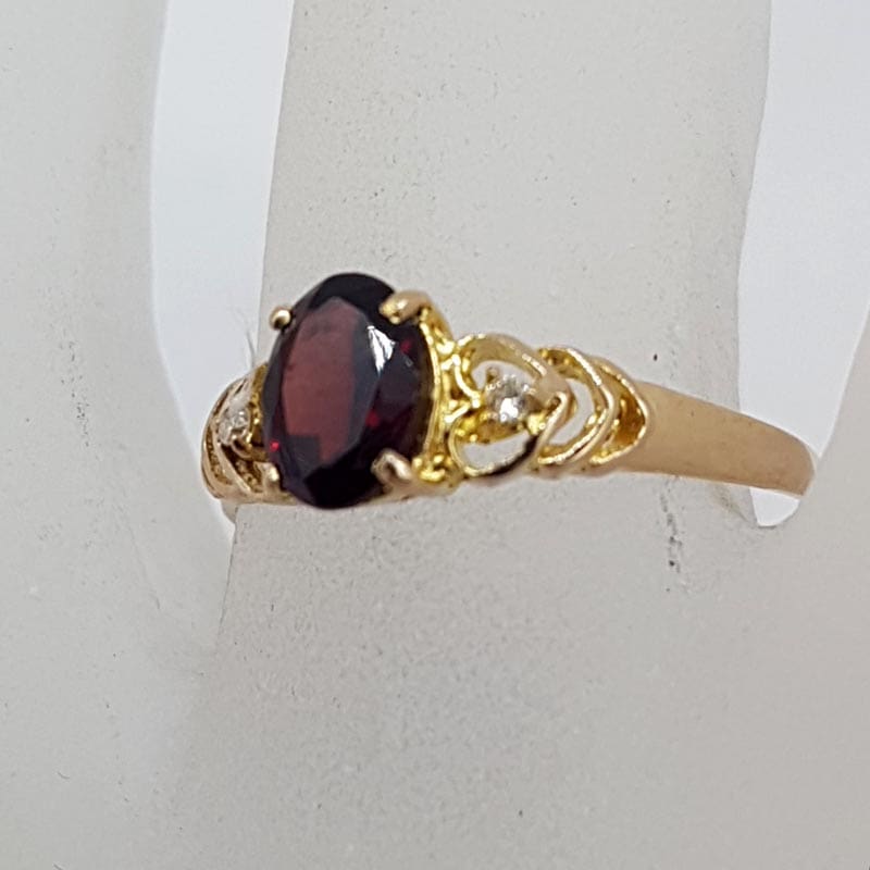 9ct Yellow Gold Oval Garnet Claw Set with Diamonds in Filigree Heart Sides Ring